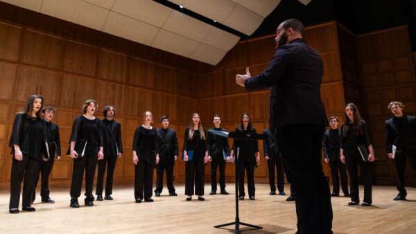 The Ϲ Chamber Choir directed by Dr. Richard Carrick pictured in the Mitchell Auditorium.