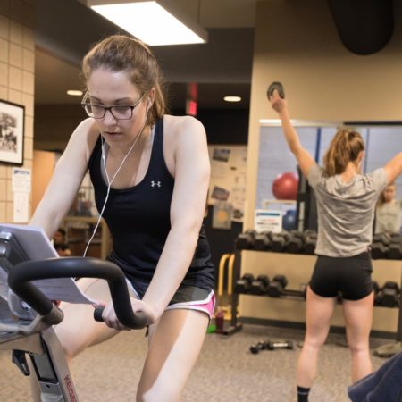 Students working out in Ϲ's Burns Wellness Commons fitness center.