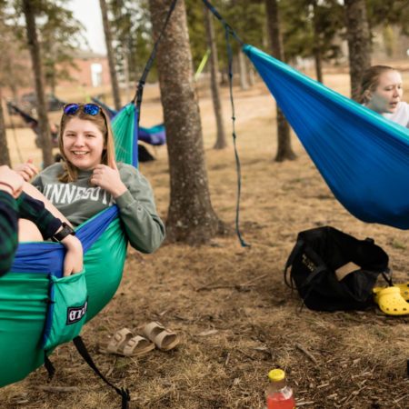 Students hanging out in Hammocks on the Duluth campus of Ϲ.