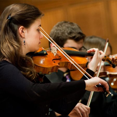 Ϲ students performing in a concert in the Mitchell Auditorium.