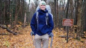 Photo of Nolan Carlson on a trail in the woods